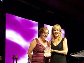 Insurance Brokers Association of Ontario's 2015 Young Broker of the Year Award recipient Crystal Underhill, left, accepts the trophy presented by Intact Insurance senior vice-president Debbie Coull-Cicchini. Underhill, a broker at Reith and Associates in St. Thomas, received her award at a gala celebration Oct. 23 in Toronto.