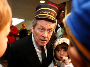 Mayor John Tory, dressed as a conductor for his proposed SmartTrack transit plan, hands out candies to kids from the City Hall daycare on Friday, Oct. 30, 2015. (MICHAEL PEAKE/Toronto Sun)