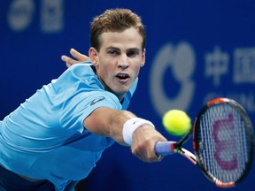Vasek Pospisil reaches for the ball against Rafael Nadal during the China Open at the National Tennis Stadium in Beijing, Wednesday, Oct. 7, 2015. (AP Photo/Andy Wong)