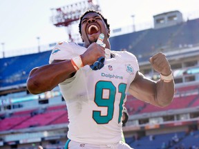 Miami Dolphins defensive end Cameron Wake celebrates as he leaves the field after beating the Tennessee Titans Sunday, Oct. 18, 2015, in Nashville, Tenn. (AP Photo/Weston Kenney)