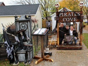 From left, Andrew Temple, Stephanie Churchill and Matthew Churchill are pictured by the pirate's cove addition to the Halloween-themed home on Shepherd Street on Wednesday October 28, 2015 in Sarnia, Ont. (Terry Bridge, The Observer)