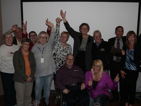 Volunteers celebrate a successful auction with Cam Tait