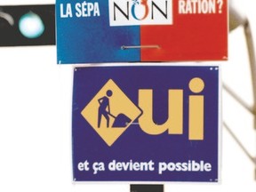 Signs supported the No and Yes campaigns hang in Quebec during the 1995 sovereignty referendum, which was narrowly won by the No side. (Postmedia Network file photo)