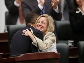 Finance Minister Joe Ceci (left) hugs Premier Rachel Notley after giving the Budget 2015 speech on the floor of the Alberta Legislature in Edmonton, Alta., on Tuesday October 27, 2015. Ian Kucerak/Edmonton Sun/Postmedia Network