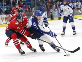 Jacob Graves, left, of the Oshawa Generals, attempt to poke the puck away from Matt Schmalz, of the Sudbury Wolves, during OHL action at the Sudbury Community Arena in Sudbury, Ont. on Friday October 30, 2015. John Lappa/Sudbury Star/Postmedia Network