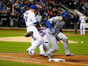 Eric Hosmer of the Kansas City Royals is safe at first base during the first inning of Game 3 of the World Series last night as Noah Syndergaard and Lucas Duda of the New York Mets get tangled up trying to make the play at Citi Field. (Getty Images/AFP)
