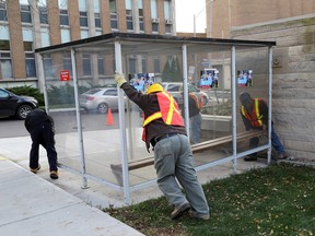 A work crew from Kingston General Hospital remove a smoking hut on the property of Kingston General Hospital in Kingston. The hospital announced a total smoking ban on its property effective Nov. 1. (Ian MacAlpine/The Whig-Standard)