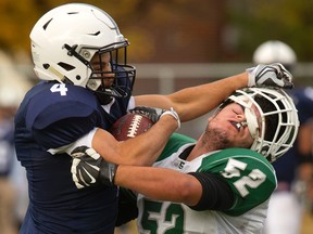 Mother Teresa?s Brennan Dower gets more than he bargained for on a straight arm from Pearson Brown of CCH, but Dower wasn?t deterred by losing his lid and made the tackle during their TVRA District senior football game at CCH on Friday. (MIKE HENSEN, The London Free Press)