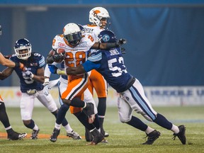 Toronto Argonauts Gregory Jones and BC Lions Chris Rainey during CFL action at the Rogers Centre in Toronto, Ont. on Friday October 30, 2015. (Ernest Doroszuk/Toronto Sun/Postmedia Network)