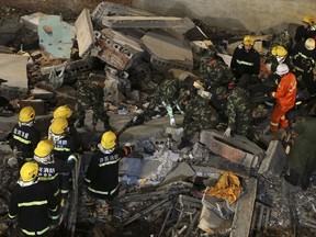 Rescuers search for survivors among debris after a residential building collapsed in Wuyang county, Henan province, China October 30, 2015. At least 17 construction workers were killed after a two-storey old house collapsed during a renovation project on Friday, local media reported. Picture taken October 30, 2015. REUTERS/Stringer