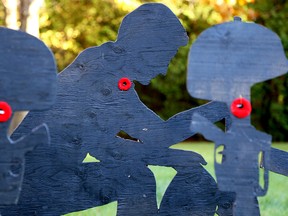 Plywood cut-outs of soldiers adorn the yard of Maurice Rivard's home just south of the Murray Canal on Friday October 30, 2015 in Carrying Place, Ont. Rivard puts the display up every year as a visual reminder for people to not forget the sacrifices made by Canada's veterans. Tim Miller/Belleville Intelligencer/Postmedia Network