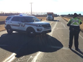 Police set up a road block at Golden Spike Road, and Highway 628, after a fatal collision on Saturday morning near Spruce Grove, AB. DAVID BLOOM/Edmonton Sun