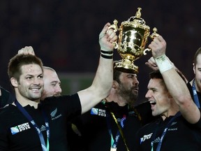 Richie McCaw of New Zealand (left) holds up the Webb Ellis trophy after winning the Rugby World Cup Final against Australia at Twickenham in London, October 31, 2015. (REUTERS/Stefan Wermuth)
