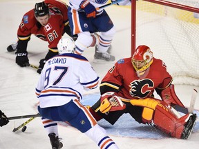 Oct 17, 2015; Calgary, Alberta, CAN; Calgary Flames goalie Jonas Hiller (1) stops a shot from Edmonton Oilers center Connor McDavid (97) at Scotiabank Saddledome. Oilers won 5-2.Candice Ward-USA TODAY Sports