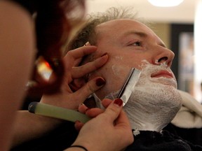 Mike Harding, a registered nurse at the Cross Cancer Institute, gets a straight shave at West Edmonton Mall on Saturday, Oct. 31, 2015, in Edmonton, Alta. to kick off the Movember campaign. CLAIRE THEOBALD Edmonton Sun