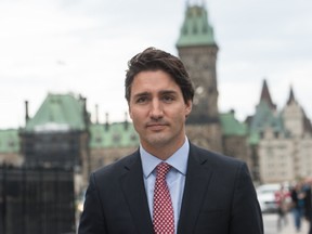 Canadian Liberal Party leader Justin Trudeau walks from the parliament to give a press conference in Ottawa on October 20, 2015. The 88-page Liberal platform has the word “immediate” or “immediately” 28 different times, attached to a whole pile of promises. AFP PHOTO/NICHOLAS KAMM