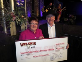 Edmonton Rodeo Cowboy's Benevolent Foundation chair Laura Gadowsky receives a $15,000 surprise donation from Welsh's owner Blaine MacMillan at Friday night's 23rd Annual Black Tie Bingo. (SUPPLIED)
