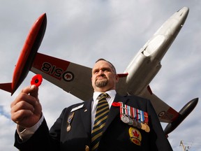 Royal Canadian Legion Branch #108 President Sean Cuppens poses for a photo with a poppy outside the branch in Leduc, Alta., on Saturday October 31, 2015. A local Sportchek store initially refused to allow members to place a box, which is part of the Legion's national Poppy Campaign, which seeks to honour those who have served in the military and to raise funds to assist veterans and their families. Ian Kucerak/Edmonton Sun/Postmedia Network