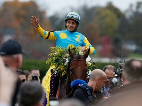 Jockey Victor Espinoza celebrates after riding American Pharoah to victory in the Breeders’ Cup Classic at Keeneland in Lexington, Ky., on Saturday, to capture racing’s Grand Slam. (AFP/PHOTO)