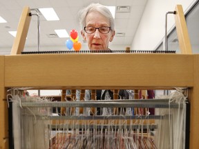 Irene Frey demonstrates use of a small loom at the annual Fibre Arts Sale put on by the Belleville Weavers and Spiiners Guild at the Quinte Sports and Wellness Centre on Saturday October 31, 2015 in Belleville, Ont. Tim Miller/Belleville Intelligencer/Postmedia Network