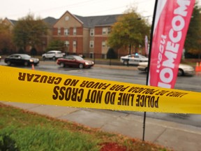 Police tape is hung along Martin Luther King Jr. Drive Sunday morning, Nov. 1, 2015, after a fatal shooting was reported around 1:20 a.m., near Wilson Hall and Gleason-Hairston Terrace on the campus of Winston-Salem State University in Winston-Salem, N.C. (AP Photo/Winston-Salem Journal, Walt Unks)