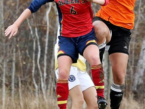 Laurentian Voyageurs goal keeper Richele Greenwood makes the save as Queen's Jessie De boer tries to head the ball during OUA womens playoff soccer action from Laurentian University in Sudbury, Ont. on Sunday, November 1, 2015. Queens defeated Laurentian 2-1.Gino Donato/Sudbury Star/Postmedia Network