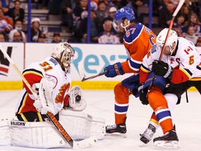 Oilers winger Benoit Pouliot is stopped during the first period of Saturday's game against the Flames at Rexall Place. (Ian Kucerak, Edmonton Sun)