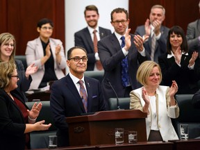 Government MLAs applaud Finance Minister Joe Ceci (centre) as he concludes his Budget 2015 speech on the floor of the Alberta Legislature in Edmonton, Alta., on Tuesday, October 27, 2015. Ian Kucerak/Edmonton Sun/Postmedia Network