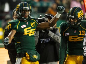 Edmonton's Derel Walker (87) celebrates his touchdown with quarterback Mike Reilly (13) during the second half of a CFL game between the Edmonton Eskimos and the Montreal Alouettes at Commonwealth Stadium in Edmonton, Alta.. on Sunday November 1, 2015. The Eskimos won 40-22. Ian Kucerak/Edmonton Sun/Postmedia Network