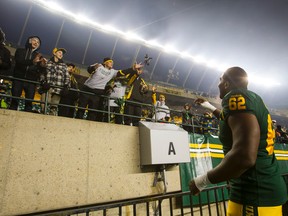 Edmonton's Chris Greaves (62) tosses his gloves to fans after the team won a CFL game between the Edmonton Eskimos and the Montreal Alouettes at Commonwealth Stadium in Edmonton, Alta.. on Sunday November 1, 2015. The Eskimos won 40-22. Ian Kucerak/Edmonton Sun/Postmedia Network
