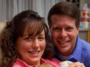 In this  2010 publicity image released by TLC, Jim Bob and Michelle Duggar hold their daughter Josie Brooklyn Duggar. An Alberta home-schooling association has cancelled an appearance by the American reality TV couple slated to speak at its upcoming annual convention. THE CANADIAN PRESS/ AP/TLC, Scott Enlow
