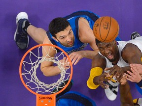 Dallas Mavericks center Zaza Pachulia, left, of Georgia, and Los Angeles Lakers center Roy Hibbert battle for a rebound during the first half of an NBA basketball game, Sunday, Nov. 1, 2015, in Los Angeles. The Lakers won 103-93. (AP Photo/Mark J. Terrill)