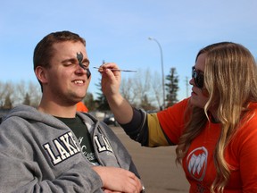Brandon Thomas stopped by the Regional Centre Friday to get his face painted by Interior Design Technology student Brenna Senger.