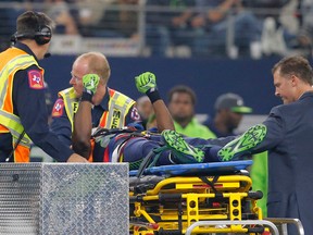 Seattle Seahawks' Ricardo Lockette holds up his hands as medical crew cart him off the field after suffering an unknown injury in the first half of an NFL football game against the Dallas Cowboys, Sunday, Nov. 1, 2015, in Arlington, Texas. (AP Photo/Brandon Wade)