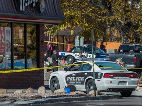 The rear window of a Colorado Springs Police car is shattered after a shooting Saturday, Oct. 31, 2015, in Colorado Springs, Colo. Multiple are dead, including a suspected gunman, following a shooting spree according to authorities. Lt. Catherine Buckley said the crime scene covers several major downtown streets. (Christian Murdock/The Gazette via AP)