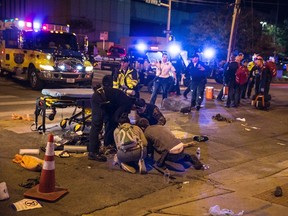 A patient who was struck by a vehicle on Red River Street during the SXSW festival is assisted by paramedics and bystanders in downtown Austin,Texas in this March 13, 2014, file photo. (REUTERS/Colin Kerrigan/Files)