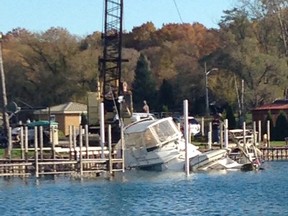Submitted photo: A Courier Press reader sent us this photo, as they were pulling a boat out of the St, Clair River that sank at a dock at Ecarte Marine in Port Lambton on Monday afternoon. They were pumping the water out of  the boat and there was a crane attached to it to pull it out.