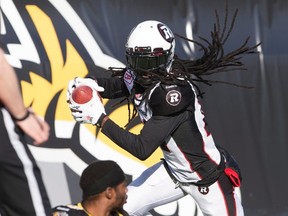 Ottawa RedBblacks' defensive back Abdul Kanneh (14) celebrates his end-zone reception while Hamilton Tiger-Cats' Brandon Banks (16), lower left, sits on the turf during second-half CFL football action in Hamilton, Ont., on Sunday, Nov. 1, 2015. THE CANADIAN PRESS/Peter Power