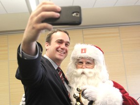 Kingston and the Islands member of Parliament elect Mark Gerretsen takes a selfie with Santa Claus after they helped launch the Family and Children's Services of Frontenac, Lennox and Addington 2015 Tree of Hope Christmas appeal in Kingston on Monday. (Michael Lea/The Whig-Standard)