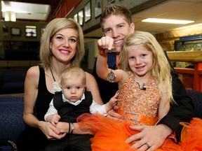 Alexis Shymanski, 5, holds her Bronze Medal for Bravery following the Royal Canadian Humane Association's Bravery and Lifesaving Investiture ceremony at EPS headquarters, in Edmonton, Alta. on Monday Nov. 2, 2015. Shymanski's actions helped save her Mother and 10 week-old brother following a June 8, 2015 car crash near Jasper. Posing with Alexis is her mother Angela Shymanski, father Travis Shymanski, and brother Peter Shymanski. David Bloom/Edmonton Sun