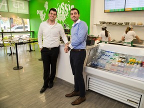 Aiden, left, and Wyatt Booth concentrate on fresh food at their new fast food restaurant, FreshBooth in London. (DEREK RUTTAN, The London Free Press)