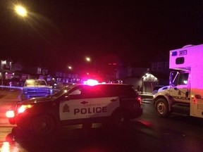 Edmonton Police Service members block the road as they investigate after two people were found dead inside a car near 173 Street and 11 Avenue SW, in Edmonton, Alta. on Friday Oct. 30, 2015. Kevin Maimann/Edmonton Sun/Postmedia Network