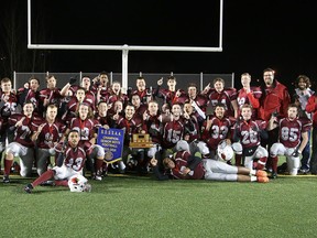 The St. Charles Cardinals senior boys football team poses with the championship banner and trophy after defeating Lo-Ellen at James Jerome Sports Complex on Monday night.
