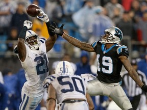 Mike Adams #29 of the Indianapolis Colts intercepts a pass as Ted Ginn #19 of the Carolina Panthers tries to stop him during their game at Bank of America Stadium on November 2, 2015 in Charlotte, North Carolina.   Streeter Lecka/Getty Images/AFP