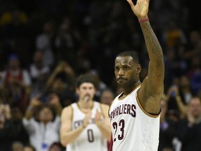 Cleveland Cavaliers' LeBron James waves to the crowd during a time out in the second half of an NBA basketball game against the Philadelphia 76ers, Monday, Nov. 2, 2015, in Philadelphia. The Cavaliers won 107-100. Lebron became the youngest player to reach 25,000 career points. (AP Photo/Michael Perez)