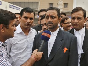 D.K. Mishra, the lawyer of driver Shiv Kumar Yadav, speaks to reporters after the sentence of an Uber driver was passed in a court in Delhi, India, November 3, 2015. (REUTERS/Anindito Mukherjee)