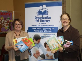 The Organization for Literacy in Lambton's Margaret Holmes and Judith Farris hold up a selection of children's books donated to the Give-a-Book campaign, which takes place from Nov. 3 to Dec. 8.
CARL HNATYSHYN/SARNIA THIS WEEK