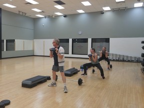Day Media Challenge participants Graham Hicks (left), Chris Reeve (middle) and Ashley Sexsmith (right) work out at World Health.