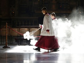 Altar boys asperse incense as they wait for the arrival of Pope Francis on the occasion of a Mass for cardinals and bishops who died in the past year, in St. Peter's Basilica at the Vatican, Tuesday, Nov. 3, 2015. (AP Photo/Gregorio Borgia, Pool)