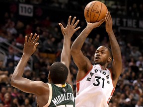 Toronto Raptors guard Terrence Ross takes a jump shot over Milwaukee Bucks forward Khris Middleton during the second half of the Raptors 106-87 win at Air Canada Centre on Nov. 1, 2015. (Dan Hamilton-USA TODAY Sports)